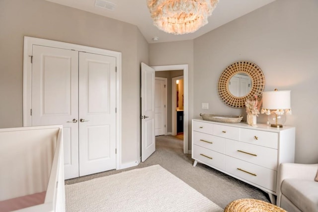 carpeted bedroom featuring a notable chandelier