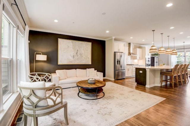 living room with crown molding and dark wood-type flooring