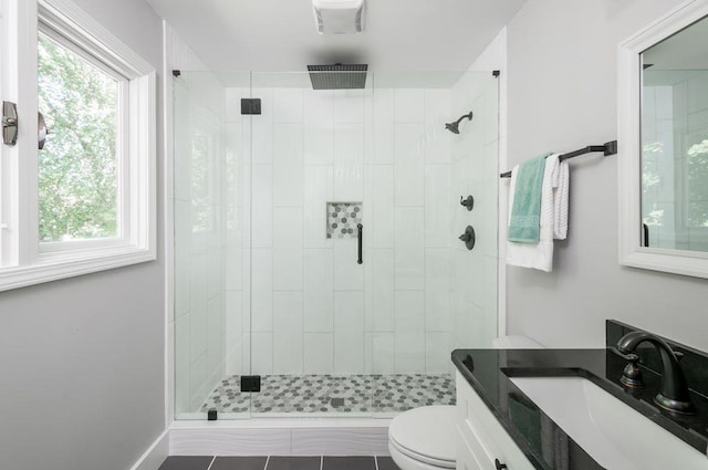 bathroom featuring a stall shower, vanity, and toilet