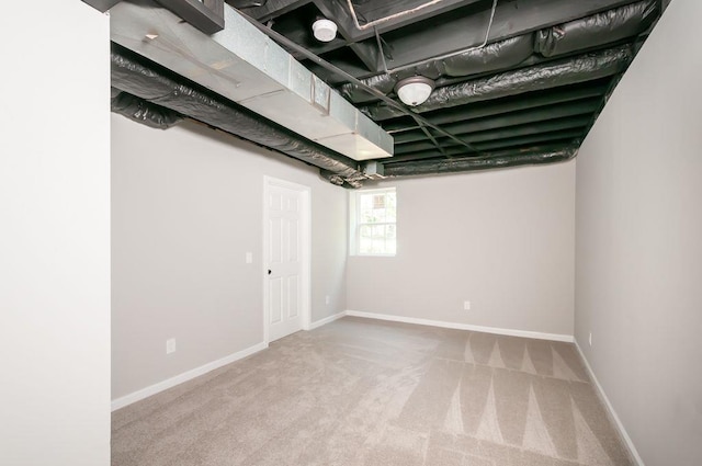 below grade area featuring carpet floors and baseboards