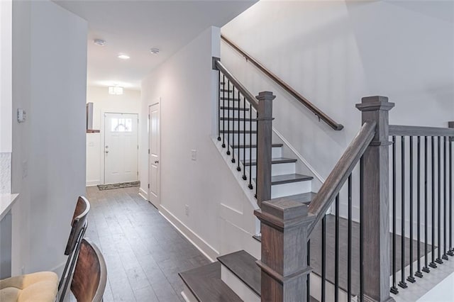 stairs featuring hardwood / wood-style flooring