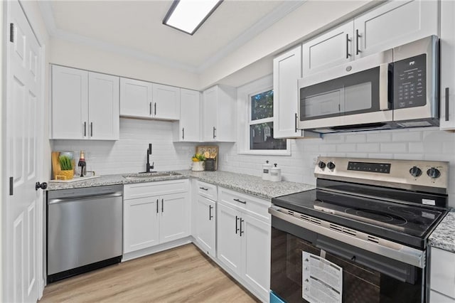 4701 Flat Shoals Rd Unit 56E, Union City, GA 30291 - kitchen featuring white cabinets, light stone counters, sink, and appliances with stainless steel finishes