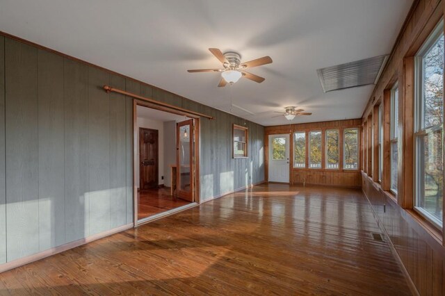 unfurnished sunroom featuring plenty of natural light and ceiling fan