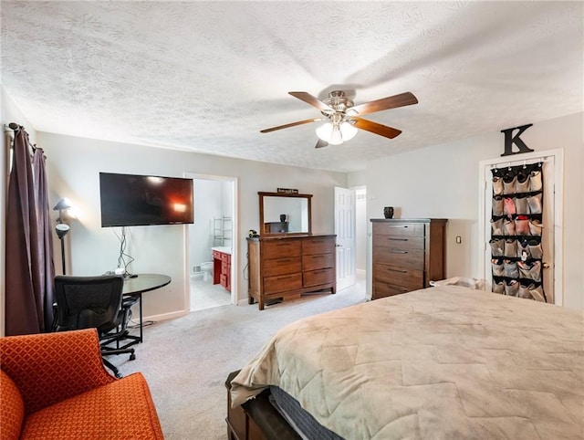 443 Rhett Dr, Loganville, GA 30052 - bedroom featuring light colored carpet, ceiling fan, ensuite bath, and a textured ceiling