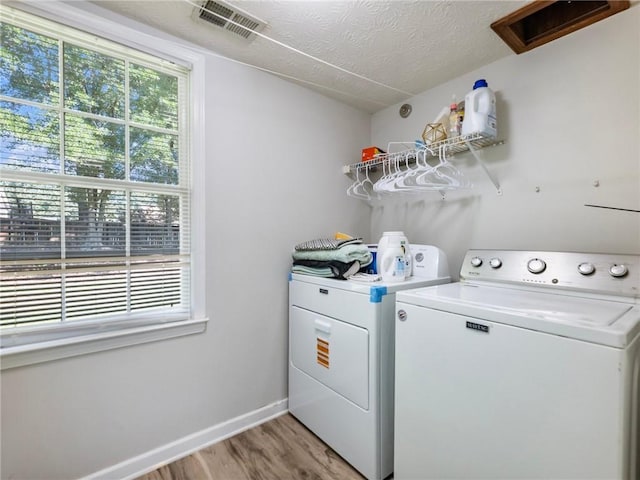443 Rhett Dr, Loganville, GA 30052 - laundry area featuring washing machine and clothes dryer and light wood-style flooring