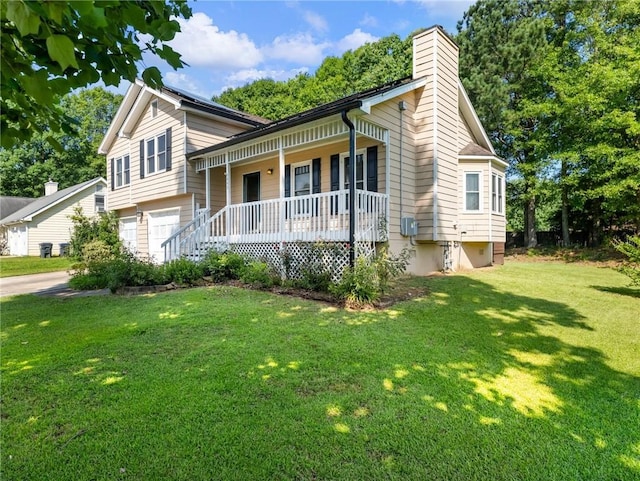 443 Rhett Dr, Loganville, GA 30052 - split level home featuring covered porch, a front lawn, a chimney, an attached garage, and driveway