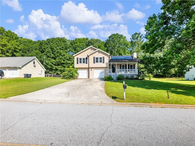 443 Rhett Dr, Loganville, GA 30052 - split level home with a porch, solar panels, a front yard, and concrete driveway