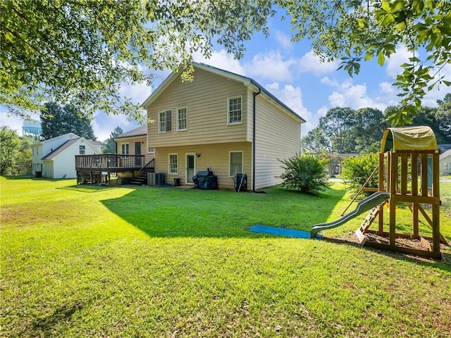 443 Rhett Dr, Loganville, GA 30052 - back of house featuring a playground, a lawn, and a deck