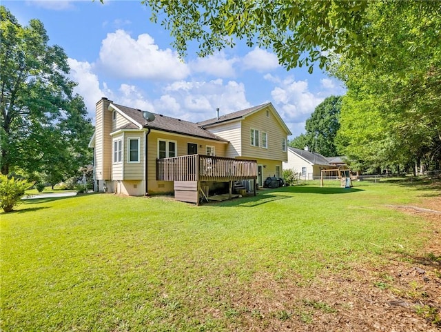 443 Rhett Dr, Loganville, GA 30052 - back of property with a wooden deck, a chimney, and a yard