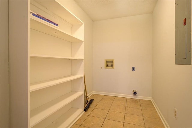 laundry area with electric dryer hookup, electric panel, hookup for a washing machine, and light tile patterned floors