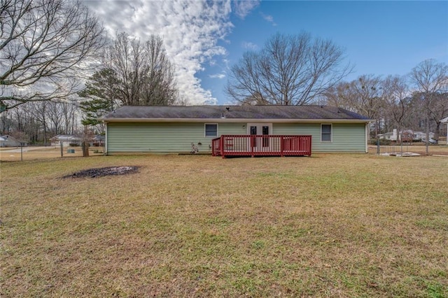 rear view of property with a yard and a deck