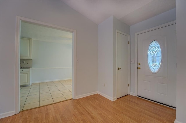 foyer featuring light hardwood / wood-style flooring and lofted ceiling