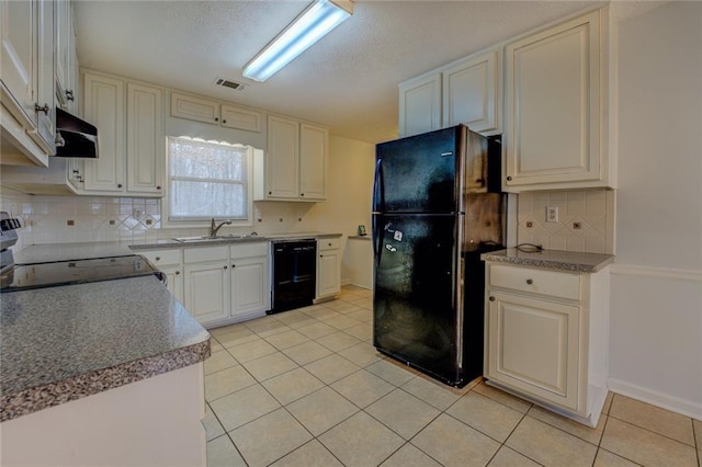 kitchen featuring decorative backsplash, sink, black appliances, white cabinets, and light tile patterned flooring