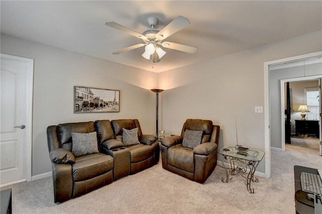 living room with ceiling fan and light colored carpet