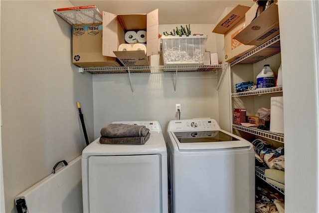 laundry area with washing machine and clothes dryer