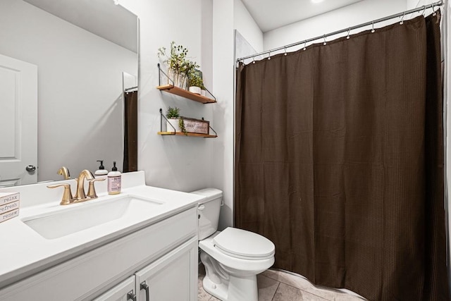 bathroom featuring vanity, tile patterned floors, and toilet