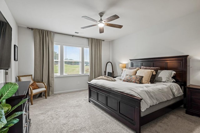 bedroom with ceiling fan and light carpet