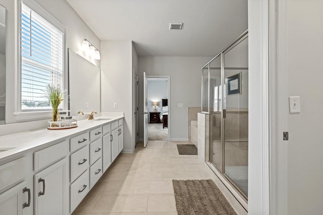 bathroom with tile patterned flooring, vanity, and a shower with shower door