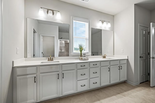 bathroom with vanity and a shower with shower door