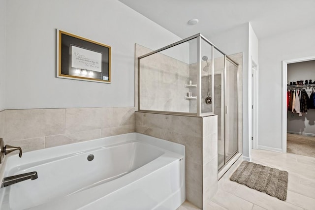 bathroom featuring tile patterned flooring and separate shower and tub