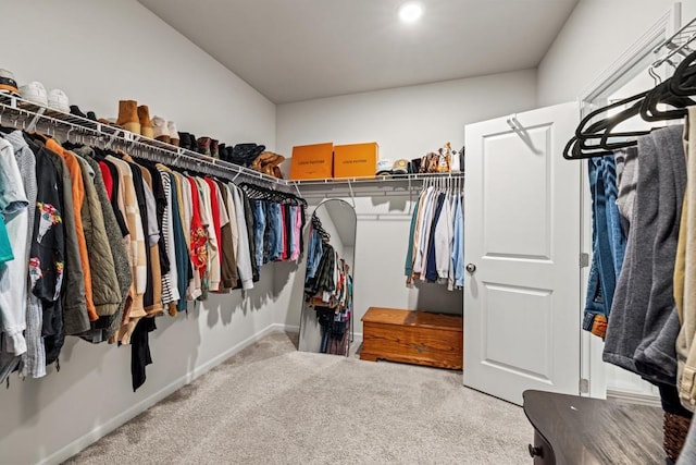 walk in closet with carpet