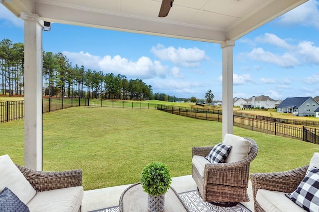 view of yard with ceiling fan and a patio area