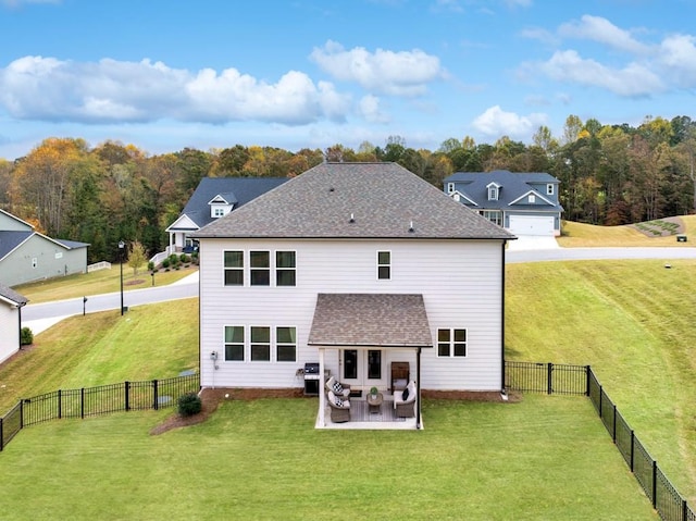 rear view of property featuring a patio and a yard