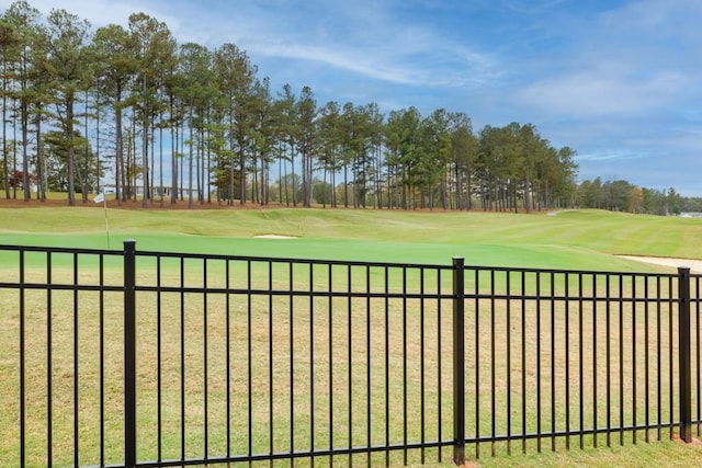 view of gate with a yard