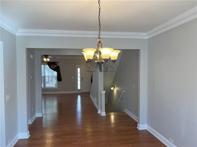 entrance foyer featuring ornamental molding, dark hardwood / wood-style flooring, and ceiling fan with notable chandelier