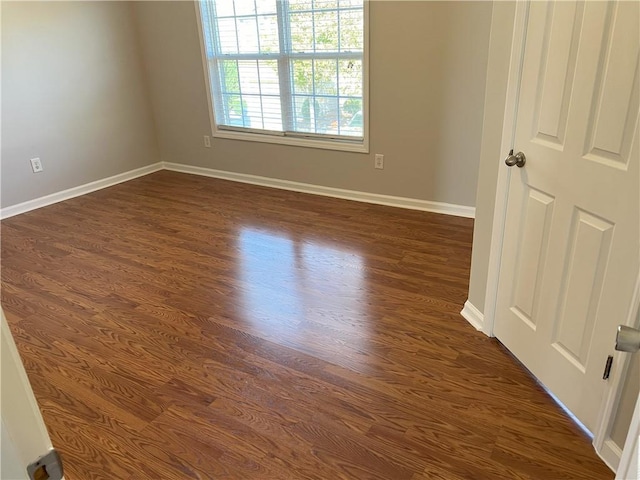 spare room featuring dark hardwood / wood-style floors