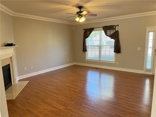 unfurnished living room featuring crown molding, ceiling fan, a high end fireplace, and dark hardwood / wood-style flooring