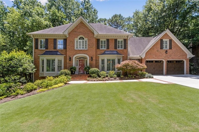 1835 Redbourne Dr, Atlanta, GA 30350 - colonial inspired home with brick siding, driveway, and a front lawn