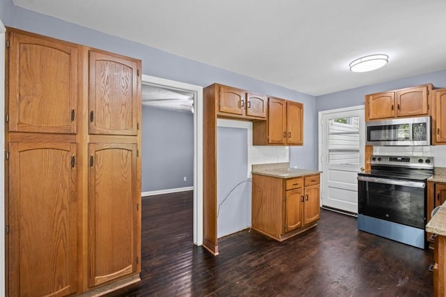 881 Mclinden Ave SE, Smyrna, GA 30080 - kitchen with stainless steel appliances, dark wood-style flooring, and light countertops