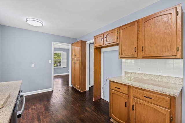 881 Mclinden Ave SE, Smyrna, GA 30080 - kitchen with dark wood finished floors, backsplash, light stone counters, and brown cabinetry