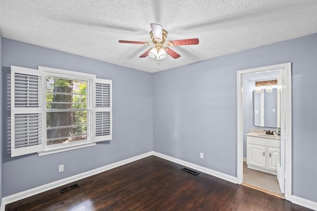 881 Mclinden Ave SE, Smyrna, GA 30080 - unfurnished bedroom featuring wood finished floors, a textured ceiling, connected bathroom, and a ceiling fan