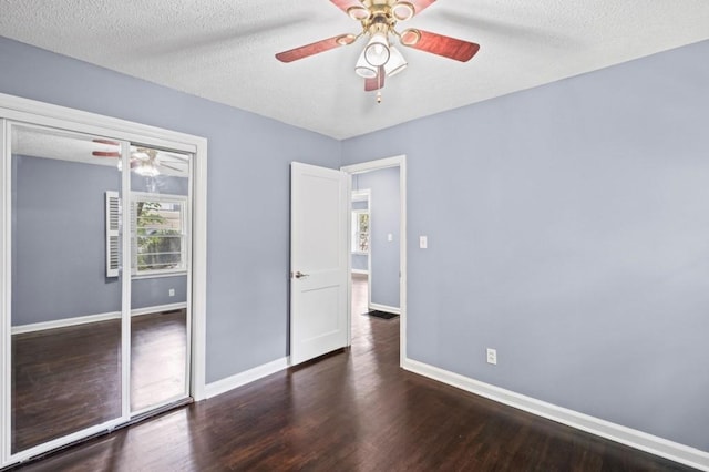 881 Mclinden Ave SE, Smyrna, GA 30080 - unfurnished bedroom with wood finished floors, a closet, a ceiling fan, and a textured ceiling