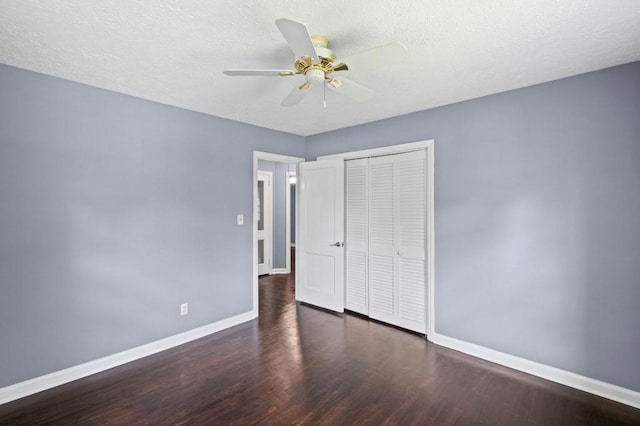 881 Mclinden Ave SE, Smyrna, GA 30080 - unfurnished bedroom featuring wood finished floors, a closet, a textured ceiling, and ceiling fan