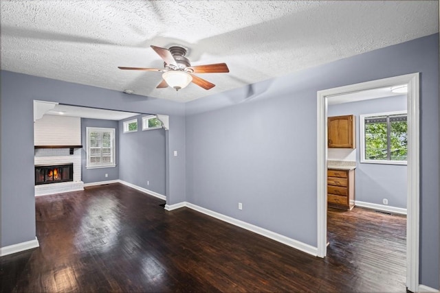 881 Mclinden Ave SE, Smyrna, GA 30080 - unfurnished living room with wood finished floors, ceiling fan, plenty of natural light, and a textured ceiling