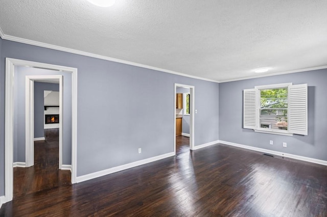 881 Mclinden Ave SE, Smyrna, GA 30080 - unfurnished room featuring wood finished floors, a textured ceiling, crown molding, and a lit fireplace