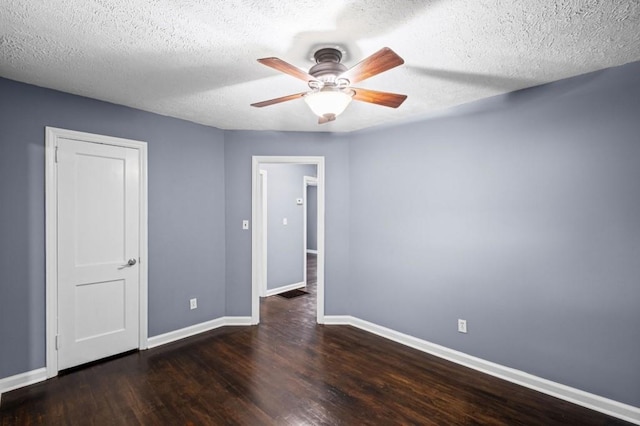 881 Mclinden Ave SE, Smyrna, GA 30080 - unfurnished bedroom featuring wood finished floors, a textured ceiling, and a ceiling fan