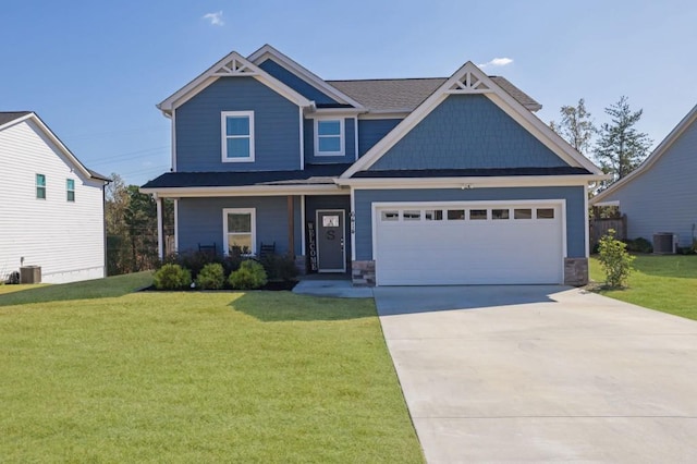 craftsman house with a front yard, cooling unit, and a garage