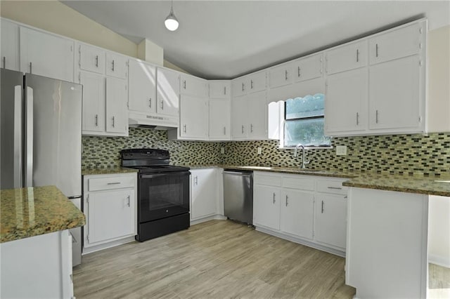 kitchen with white cabinets, appliances with stainless steel finishes, backsplash, and vaulted ceiling