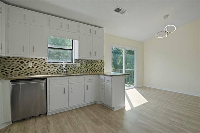 kitchen with dishwasher, decorative backsplash, white cabinetry, and sink