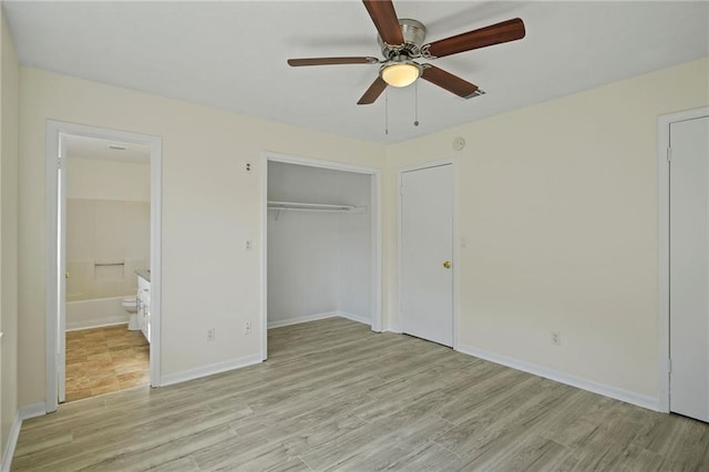 unfurnished bedroom featuring connected bathroom, ceiling fan, and light hardwood / wood-style flooring