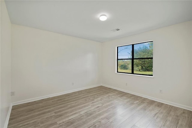 spare room with light hardwood / wood-style flooring