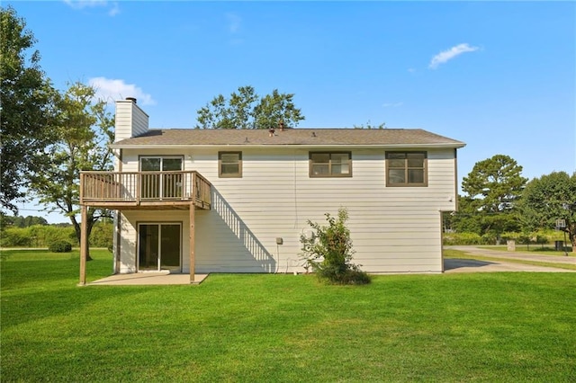 rear view of property with a yard and a patio area