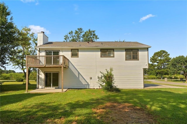 back of property featuring a lawn and a patio area