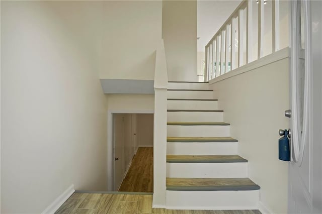 staircase with hardwood / wood-style floors