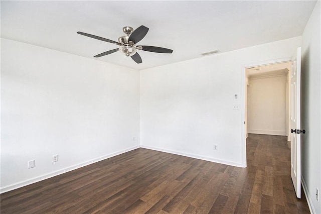 unfurnished room featuring a ceiling fan, dark wood finished floors, and baseboards