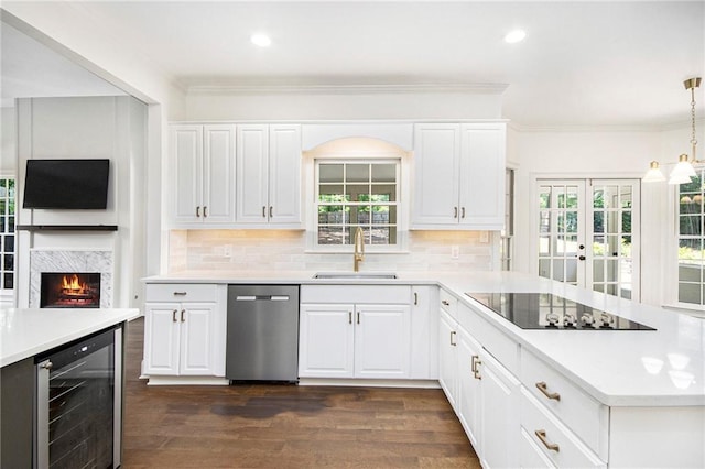 kitchen featuring a sink, stainless steel dishwasher, wine cooler, black electric stovetop, and light countertops
